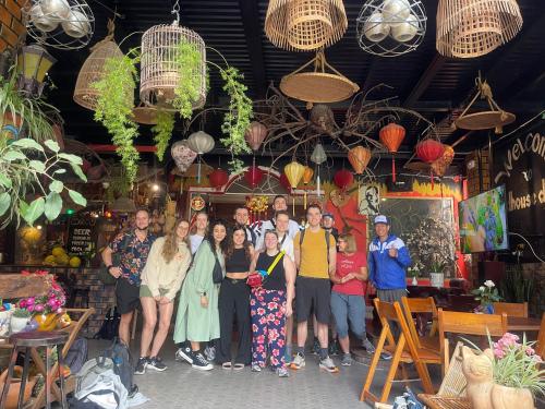 a group of people posing for a picture in a store at Redhouse Dalat Hotel in Da Lat