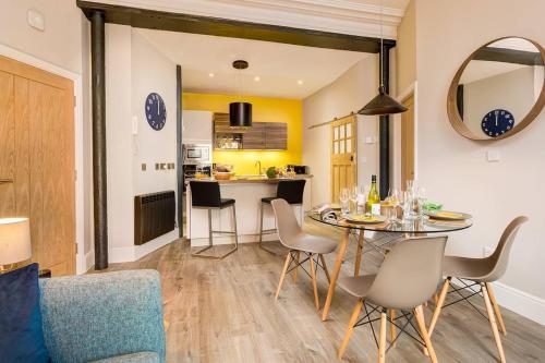 a dining room and kitchen with a table and chairs at No 1, Midland Bank Chambers in Ambleside