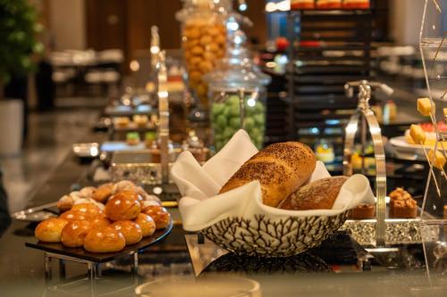 a buffet with bread and pastries on a table at Holiday Inn Hangzhou GCEC in Hangzhou