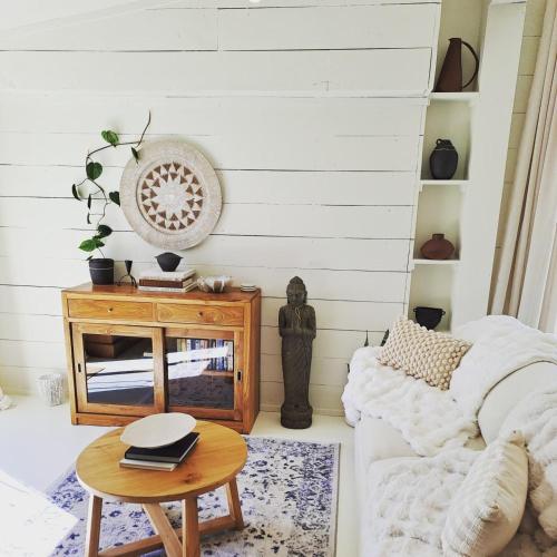 a living room with a couch and a table at Waterlily Guesthouse Māpua in Mapua