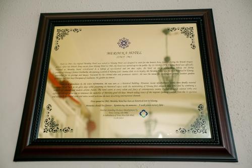 a picture of a menu in a frame at Merdeka Hotel Kluang in Kluang