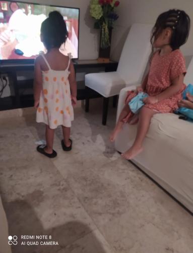 two little girls standing in front of a couch at Casa real del palmar in La Sabana