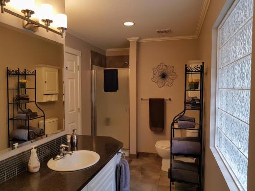 a bathroom with a sink and a toilet at Peachland Lake View Spectacular! in Peachland
