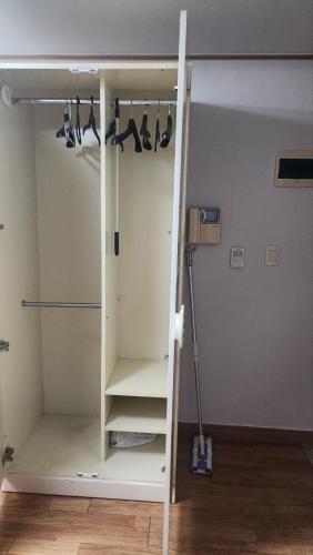 a closet with hangers and shelves in a room at Kiman09 in Seoul