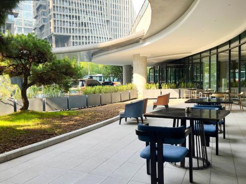a patio with a table and chairs in a building at Holiday Inn - Nanjing South Station by IHG in Nanjing