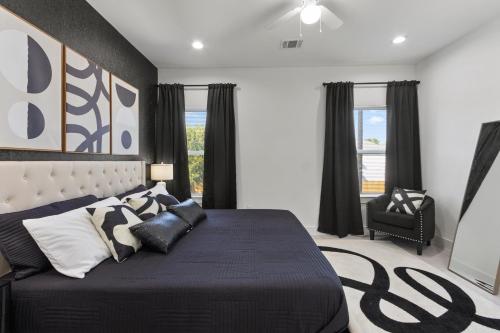 a bedroom with a large bed with black and white pillows at Stylish 3 Bedroom Rental - Just Minutes from Dowtown Houston in Houston