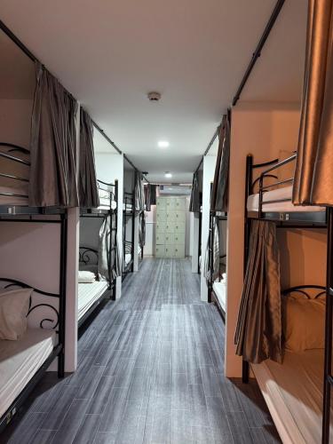 a corridor of a dorm room with bunk beds at Jomtien Beach Hostel - Soi 7 Prime Spot - 200m to Beach next to Food Market in Jomtien Beach