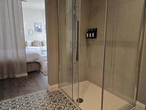 a shower with a glass door in a bathroom at Casa Fellin 1891 B&B in Cles