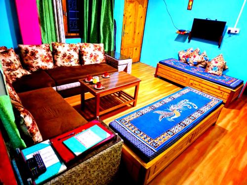 a living room with a couch and a table at Village Cafe Homestay in Kalimpong