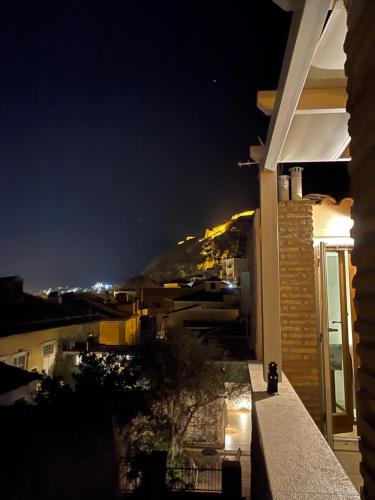 a view of a city at night from a house at Bella's Rustic Suites in Nafplio