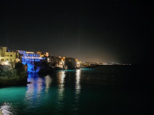 a view of a river at night with buildings at Trame - Poesia Di Mare in Polignano a Mare