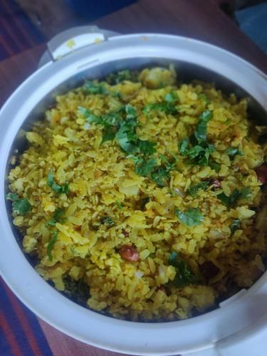 a bowl of rice with greens on top of it at Whispering Meadows U get entire 3 BHK in Shimla