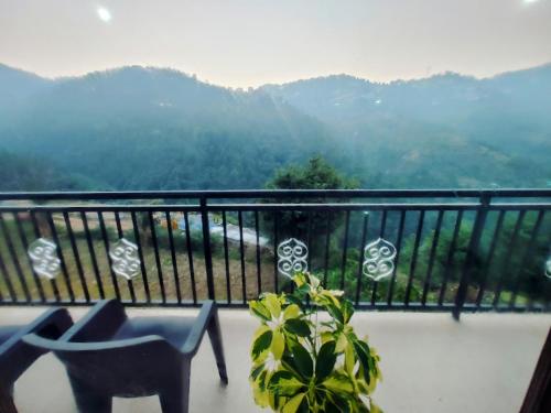 a balcony with a view of a mountain at Whispering Meadows U get entire 3 BHK in Shimla