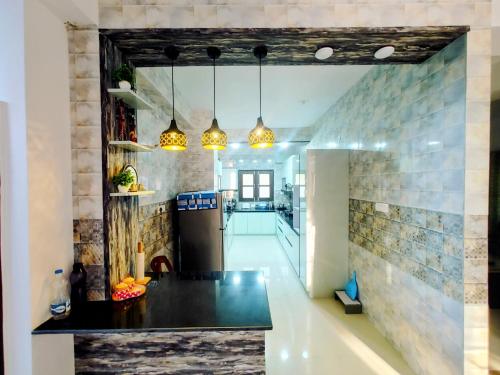 a kitchen with a black counter top in a room at Whispering Meadows U get entire 3 BHK in Shimla