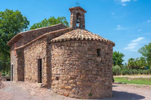 an old stone church with a cross on top at Villa Maolo in Roquebrune-sur-Argens