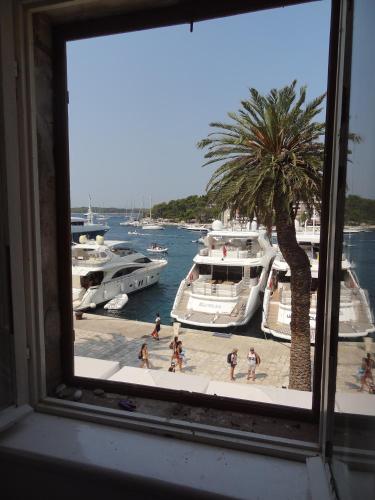 a group of people walking on a dock with boats at Inn Town Center in Hvar