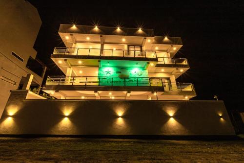 a large building with lights on it at night at Ocean Front Villa in Hikkaduwa