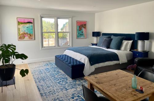 a bedroom with a bed and a couch and a table at Port Fairy BNB - The Blue Suite in Port Fairy