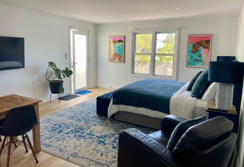 a bedroom with a bed and a desk and a chair at Port Fairy BNB - The Blue Suite in Port Fairy