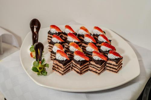 a white plate with chocolate desserts on a table at Swiss-Belinn Nairobi in Nairobi