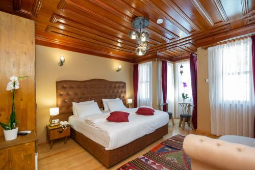 a bedroom with a large bed with a wooden ceiling at Wonder Wood Hotel in Istanbul