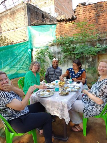 a group of people sitting around a table at Orchha Best Homestay in Orchha