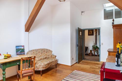 a living room with a couch and a table at Ferienunterkünfe Beim Posthalter in Oberammergau