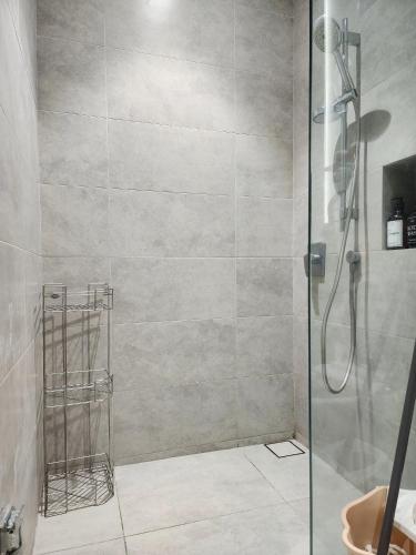 a shower with a glass door in a bathroom at Luxury DoubleTree Hill10 Residence at i-City , free parking H2901 in Shah Alam