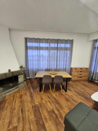 a room with a table and chairs and a window at Beach Apartment A in Néa Karváli