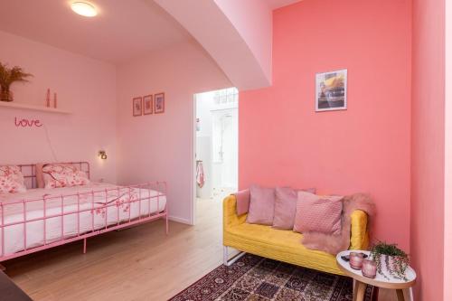 a living room with a bed and a couch at Bed & Stay Kersenbloesem in Nijswiller
