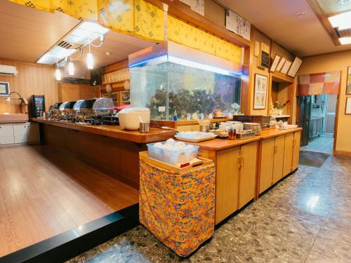 a large kitchen with a fish tank in the middle at Hotel New Century in Okinawa City