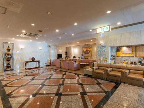 a large lobby with couches and a store at Hotel New Century in Okinawa City