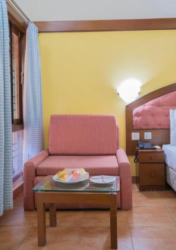 a living room with a couch and a table at Toshali Sands Nature Escape Puri in Puri