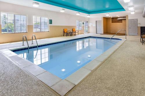 a large pool with blue water in a building at La Quinta Inn & Suites by Wyndham Norfolk in Norfolk