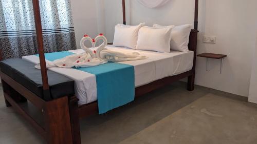 a bedroom with a bed with towels on it at Hiriketiya Hideaway in Dickwella
