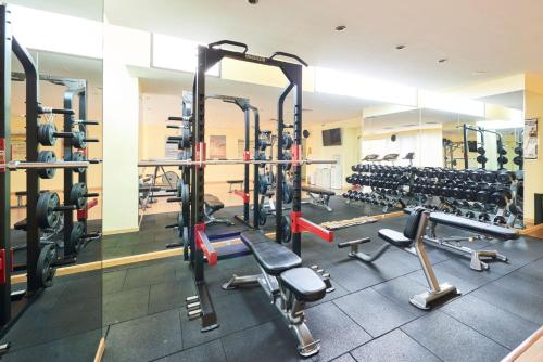 a gym with a lot of equipment in a room at Hanoi Hotel in Hanoi