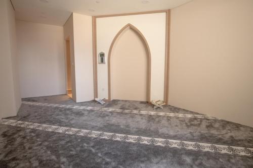 an empty hallway with an archway in a room at Jood Hotel Apartments in Dubai
