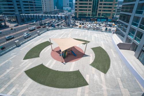an overhead view of a patio with an umbrella at Jood Hotel Apartments in Dubai
