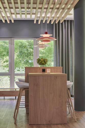 a kitchen with a table with a bowl of fruit on it at Holiday Inn Express Cologne Troisdorf by IHG in Troisdorf