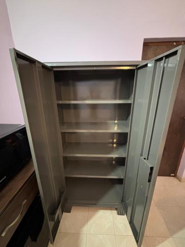 a glass cabinet in a kitchen at Angelina guest house, Anjuna Beach Road in Anjuna