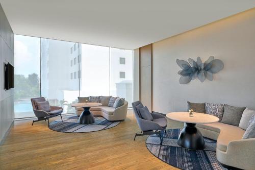 a lobby with couches and chairs and tables at Marriott Executive Apartments Penang in George Town