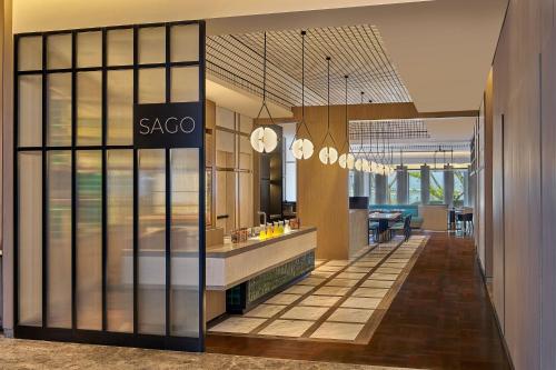 a lobby with a saccao sign on a glass wall at Marriott Executive Apartments Penang in George Town