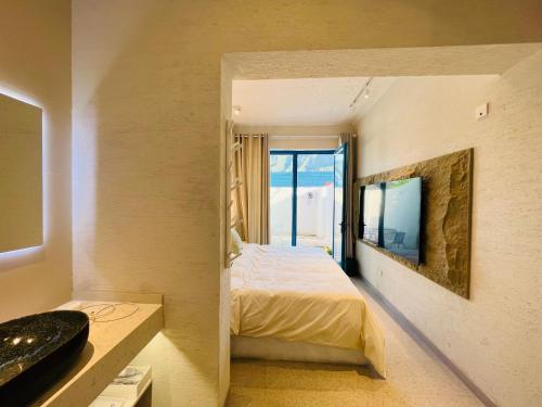 a bedroom with a bed and a television in it at 北京怀柔方糖民宿 in Sanduhe