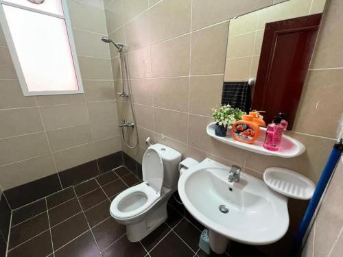 a bathroom with a toilet and a sink at Beautiful Salalah Beach Apartments - 1 by Beautiful Salalah Tours in Salalah