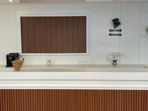 a kitchen with a large sink and a window at Hotel Clermont Airport in Aulnat