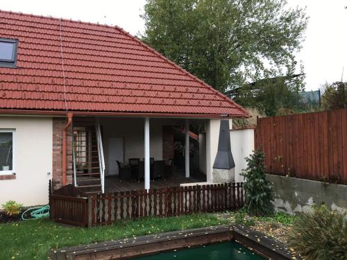 a house with a red roof and a swimming pool at Johnyho Bydlení Velikovská 10, Zlín-Štípa in Zlín