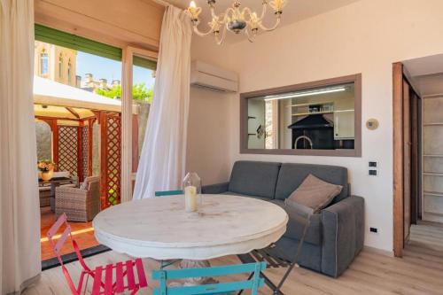 a living room with a table and a couch at Casa Primavera in Finale Ligure