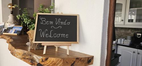 a chalkboard sign on a counter in a kitchen at Quinta Penedo das Antas in Sertã