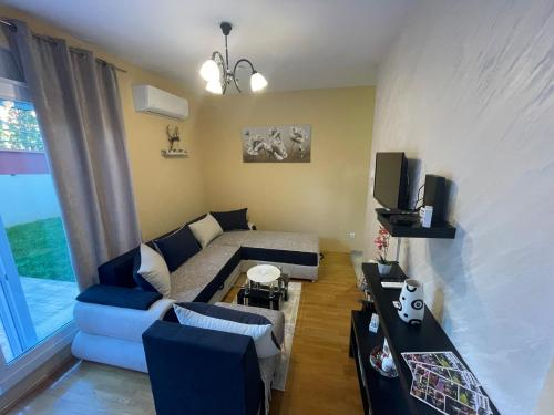 a small living room with a couch and a bed at Apartman Bella vita 2 in Zlatibor