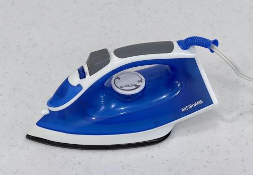 a blue and white telephone sitting on a counter at trias527 2-2 in Tokyo